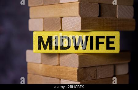 Midwife Word Written In Wooden Cube on wooden background. Stock Photo