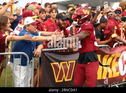 Ashburn, United States. 08th Aug, 2023. Washington Commanders cornerback  Rachad Wildgoose (37) high fives fans as he makes his way down to the  practice field on August 8th 2023 at the OrthoVirginia