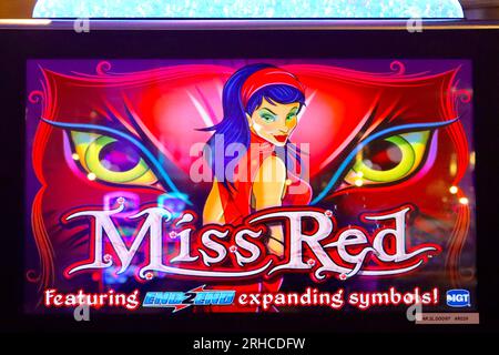 Illuminated header panel with stylised graphics mounted on an Arcade Slot machine promoting gaming recreation to cruise ship guests on Arcadia. Stock Photo