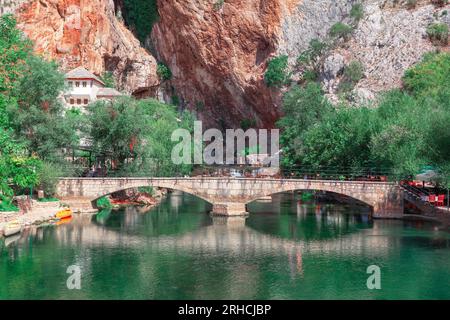 Vrelo Bune at Buna river in Bosnia and Herzegovina . Arch bridge over the river . Beautiful view of a bridge over the river in the gorge Stock Photo