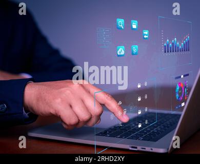Analyst working with business analytics and data management system on computer, make a report with KPI and metrics connected to database. Corporate st Stock Photo