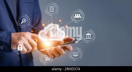 Businessman uses a smartphone with cloud computing diagram shown up a hand. Cloud technology. Networking and internet service concept. Cloud storage a Stock Photo