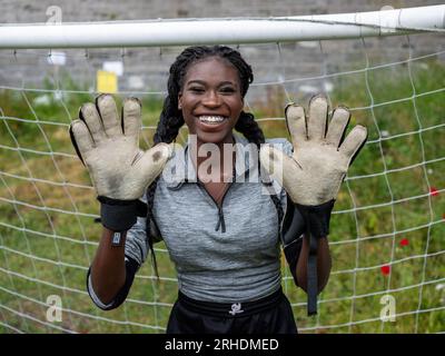 close up of a woman wearing leggings holding a football, sports