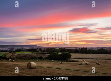 Dramatic August harvest afterglow sunset from Wilmington Hill on the south downs in east Sussex south east England UK Stock Photo