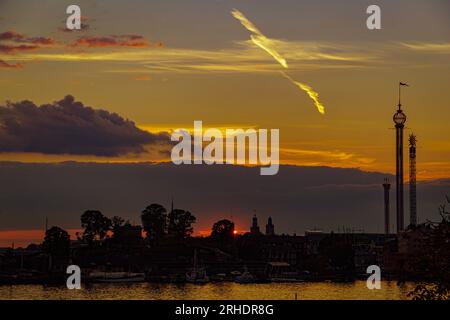 Silhouette trees and buildings against sky during sunset Stock Photo