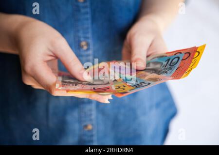 Woman's hands holding australian cash notes Stock Photo