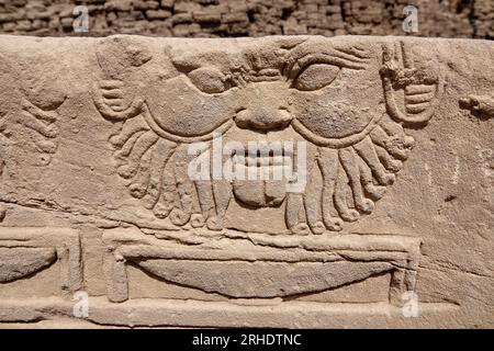 Carving of god Bes In the outer courtyard at Denderah Temple, near Qena, Egypt Stock Photo