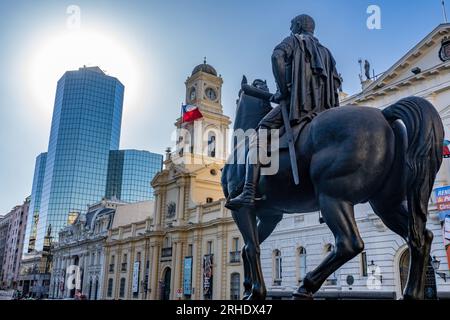 The equestrian statue of Don Pedro de Valdivia in the Plaza de Armas De San Fernando, Santiago, Chile.  Behind is the Palacio de la Real Audiencia de Stock Photo