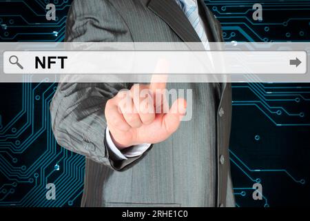 Businessman pushing virtual search bar with NFT acronym Non Fungible Token, on digital background close-up Stock Photo