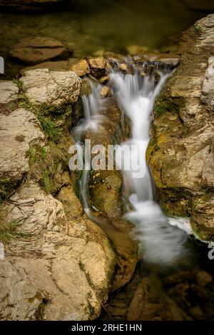 Riera de la Malatosca stream, going down between rocks, on the way to Sant Joan de les Abadesses village, Ripollès, Girona, Catalonia, Spain, Pyrenees Stock Photo