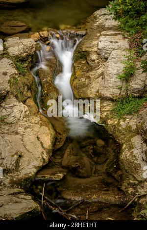 Riera de la Malatosca stream, going down between rocks, on the way to Sant Joan de les Abadesses village, Ripollès, Girona, Catalonia, Spain, Pyrenees Stock Photo