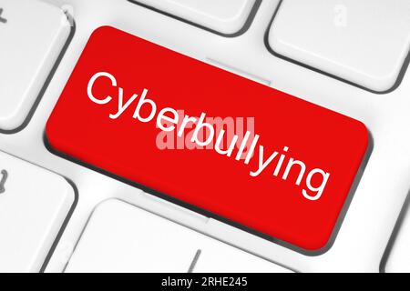 Red button with Cyberbullying word on the keyboard close-up, technology concept Stock Photo