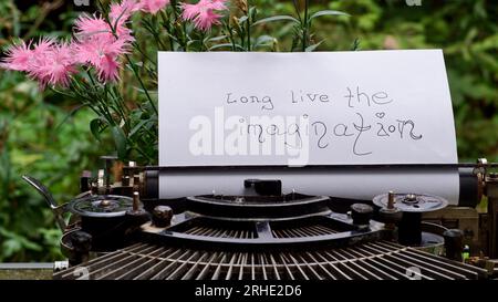 Vintage typewriter with paper saying "long live the imagination". Stock Photo