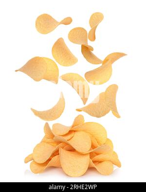 Potato chips falling to potato chips heap, on white background, levitation concept close-up Stock Photo
