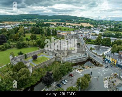 Aerial view of Cahir castle and town in Ireland with Tower House, outer castle, circular, rectangular towers, banquette hall, guarding the crossing Stock Photo