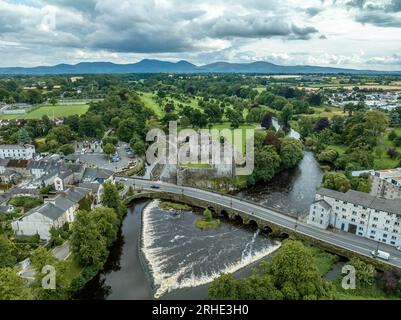 Aerial view of Cahir castle and town in Ireland with Tower House, outer castle, circular, rectangular towers, banquette hall, guarding the crossing Stock Photo