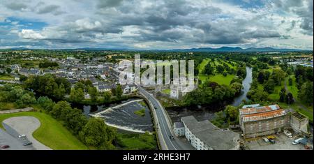 Aerial view of Cahir castle and town in Ireland with Tower House, outer castle, circular, rectangular towers, banquette hall, guarding the crossing Stock Photo