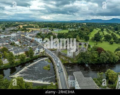 Aerial view of Cahir castle and town in Ireland with Tower House, outer castle, circular, rectangular towers, banquette hall, guarding the crossing Stock Photo