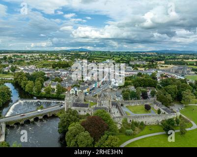 Aerial view of Cahir castle and town in Ireland with Tower House, outer castle, circular, rectangular towers, banquette hall, guarding the crossing Stock Photo