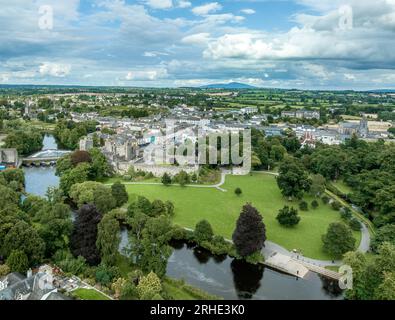 Aerial view of Cahir castle and town in Ireland with Tower House, outer castle, circular, rectangular towers, banquette hall, guarding the crossing Stock Photo