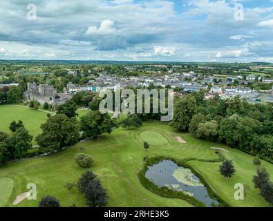 Aerial view of Cahir castle and town in Ireland with Tower House, outer castle, circular, rectangular towers, banquette hall, guarding the crossing Stock Photo