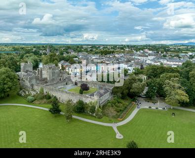 Aerial view of Cahir castle and town in Ireland with Tower House, outer castle, circular, rectangular towers, banquette hall, guarding the crossing Stock Photo