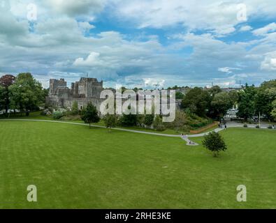 Aerial view of Cahir castle and town in Ireland with Tower House, outer castle, circular, rectangular towers, banquette hall, guarding the crossing Stock Photo