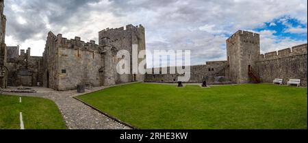 Aerial view of Cahir castle and town in Ireland with Tower House, outer castle, circular, rectangular towers, banquette hall, guarding the crossing Stock Photo