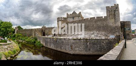 Aerial view of Cahir castle and town in Ireland with Tower House, outer castle, circular, rectangular towers, banquette hall, guarding the crossing Stock Photo