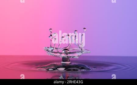 Water splash like crown on color background close-up Stock Photo