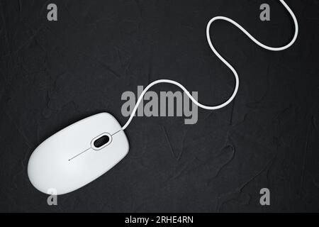 White modern wired computer mouse on black background. Computer technology concept Stock Photo