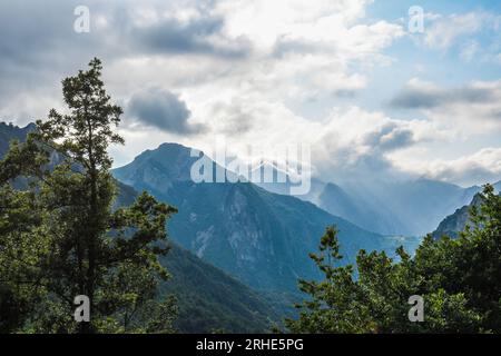 Sunbeams between the clouds and mountains of Somiedo, Asturias Stock Photo