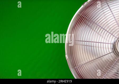 electric fan isolated on a green background, close-up on the left there is a place for an inscription. High quality photo Stock Photo