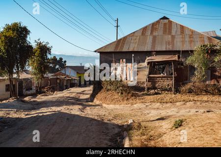 Scenic view of small scale maize farms with houses at Mbeya Town in Tanzania Stock Photo