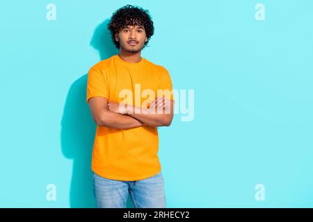Photo of confident young guy folded arms wearing trendy t shirt serious face student best scientist isolated on cyan color background Stock Photo