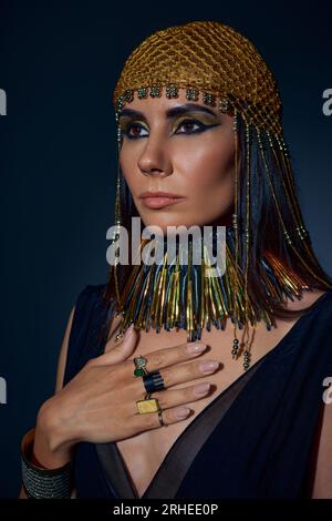Beautiful Woman In Egyptian Attire And Headdress Holding Flail While 