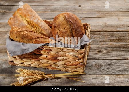 Assorted bread varieties in a charming basket, ready to be enjoyed Stock Photo