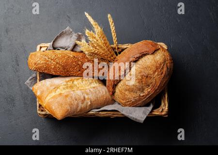 Assorted bread varieties in a charming basket, ready to be enjoyed. Flat lay Stock Photo