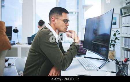 Programmer man, software development and thinking at computer for coding, software script or cyber security. Technician person with technology for Stock Photo