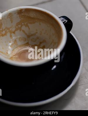 empty coffee cup, patterns on coffee ceramic, on concrete table and green ceramic cup Stock Photo