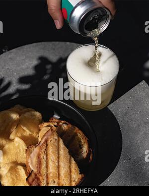 roasted bread with meat and french fries, serving beer in glass cup, cold ready to eat on concrete table, mexico latin america Stock Photo