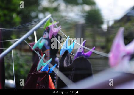 Washing hung out to dry on a line with blurry background Stock Photo