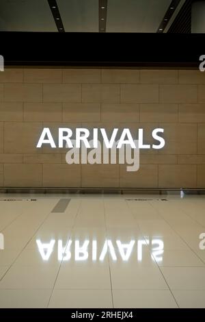 Arrivals sing on the wall in the airport Stock Photo