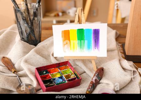 Mini easel with paints strokes in artist's studio Stock Photo