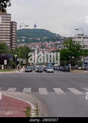 Street known as Sniper Alley during Bosnian War with TV aka Broadcasting Tower on hill. Sarajevo, Bosnia and Herzegovina, August 16,2023. Stock Photo