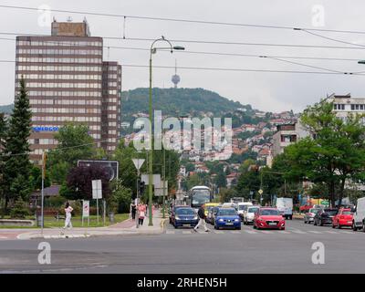 Street known as Sniper Alley during Bosnian War with TV aka Broadcasting Tower on hill. Sarajevo, Bosnia and Herzegovina, August 16,2023.. Stock Photo
