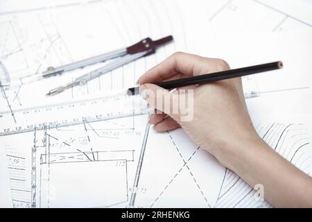 Hands of engineer working on a construction plan Stock Photo