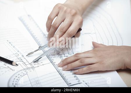 Hands of engineer working on a construction plan Stock Photo
