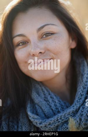 Young adult woman outdoors smiling and looking at camera Stock Photo