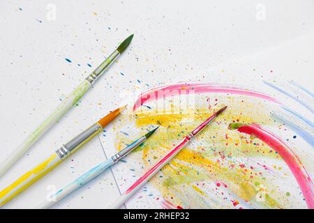 Artist's brushes with paints on white background Stock Photo